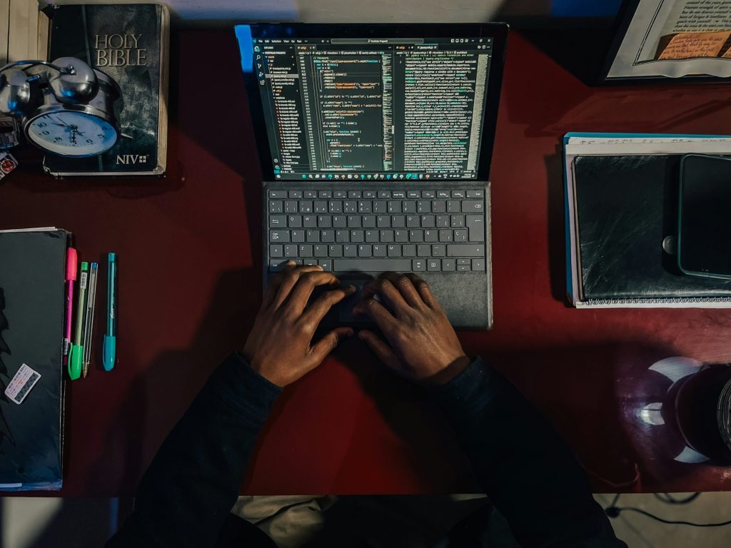 A person sitting at a desk with a laptop